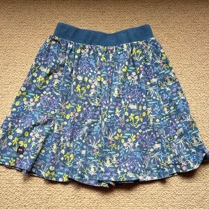 Tea skirt with attached biker shorts. Blue with flowers, and animals. Size 6.